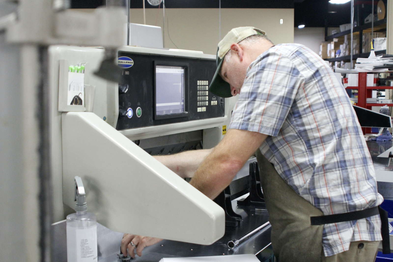 Man operates paper cutter